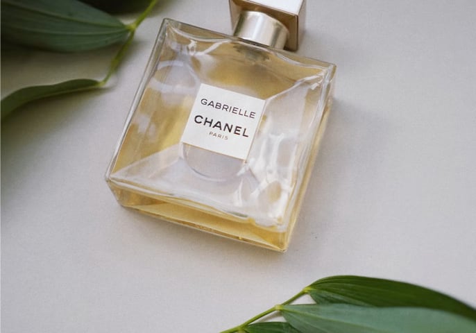 bottle of perfume with leafy background